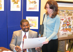 Frank Jones signs a copy of the StopKat Activity Book